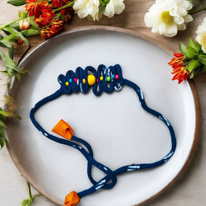 Handmade Blue Zig Zag Upcycled Fabric Rakhi With Roli Chawal For Brother - Styled on Decorative Plate