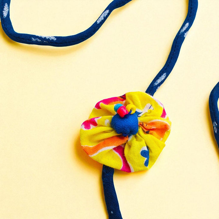 Handmade Flower Design Upcycled Fabric Rakhi With Roli Chawal For Brother - Close-up of Patterned Flower Pendant
