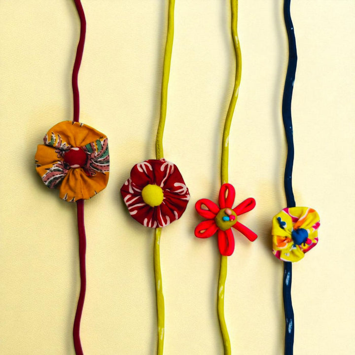 Handmade Flower Design Upcycled Fabric Rakhi With Roli Chawal For Brother - Multiple Necklace Front View