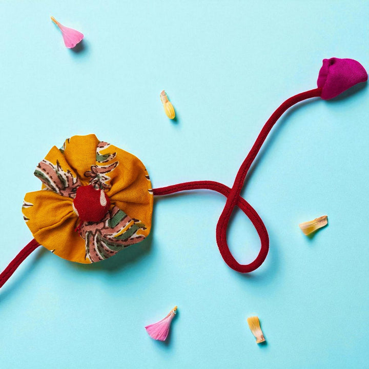 Handmade Yellow Flower Pom Pom Design Upcycled Fabric Rakhi With Roli Chawal For Brother - Full View with Floral Accents