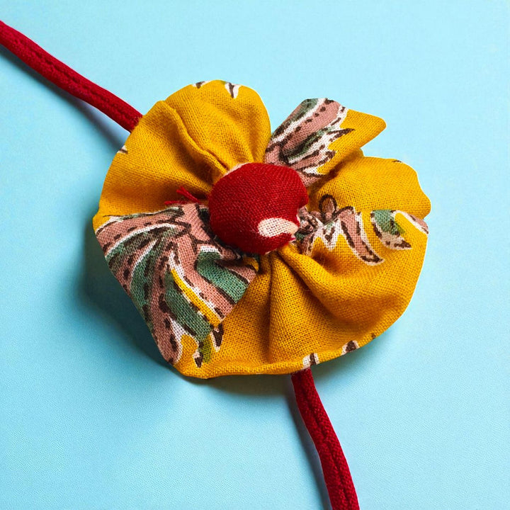 Handmade Yellow Flower Pom Pom Design Upcycled Fabric Rakhi With Roli Chawal For Brother - Close-up of Fabric Flower Detail