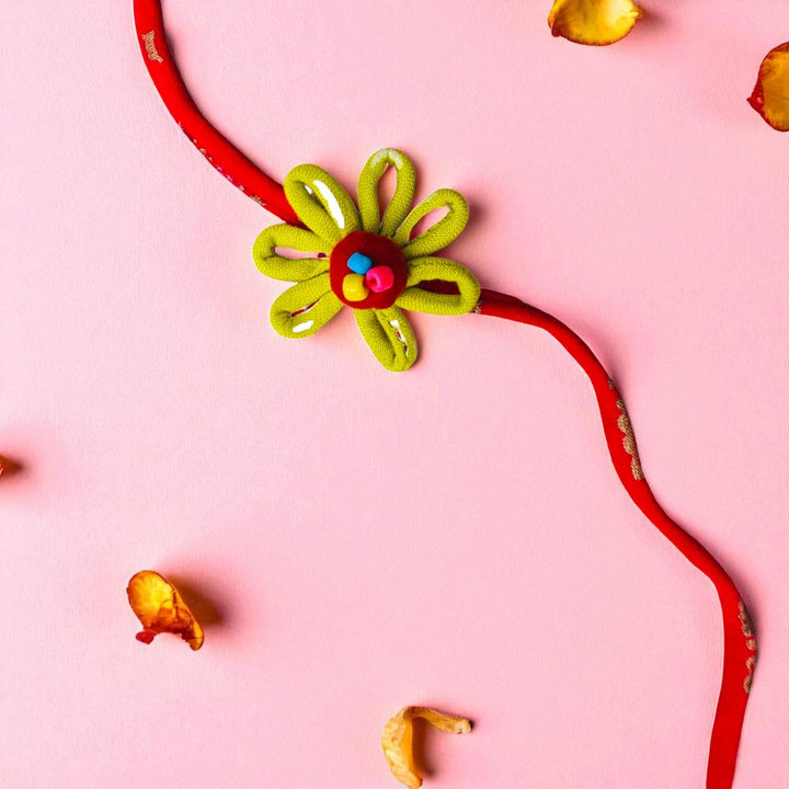 Handmade Loop Petal Flower Design Upcycled Fabric Rakhi With Roli Chawal For Brother - Flat Lay Showing Entire Item