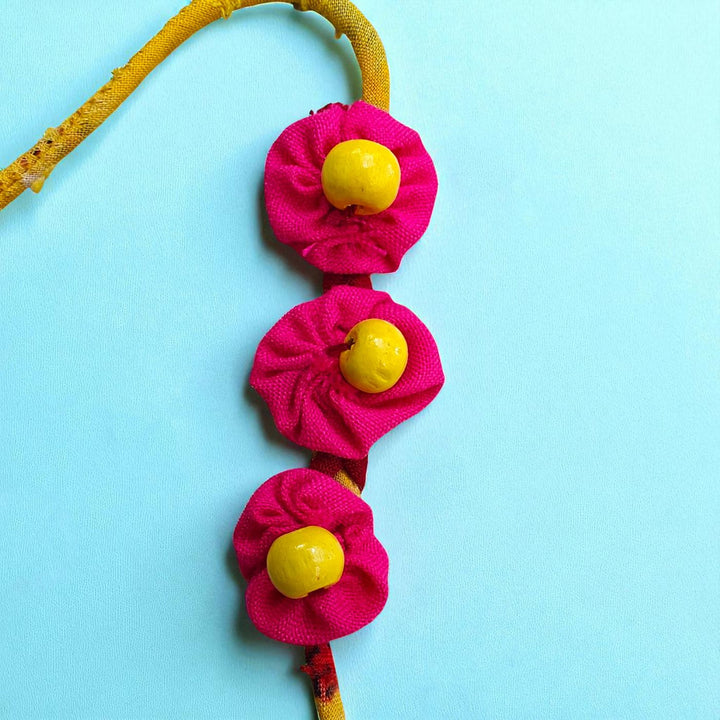 Handmade Beaded Pink And Yellow Upcycled Fabric Rakhi With Roli Chawal For Brother - Close-up of Flower Decor