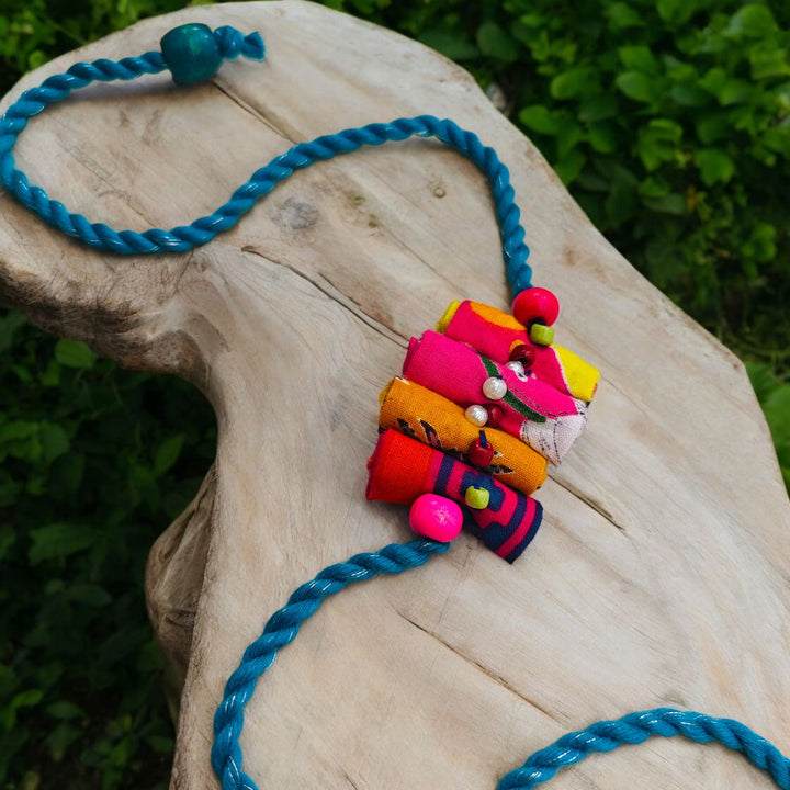 Handmade Beaded Roll Stacked Design Upcycled Fabric Rakhi With Roli Chawal For Brother - Styled on Wooden Surface