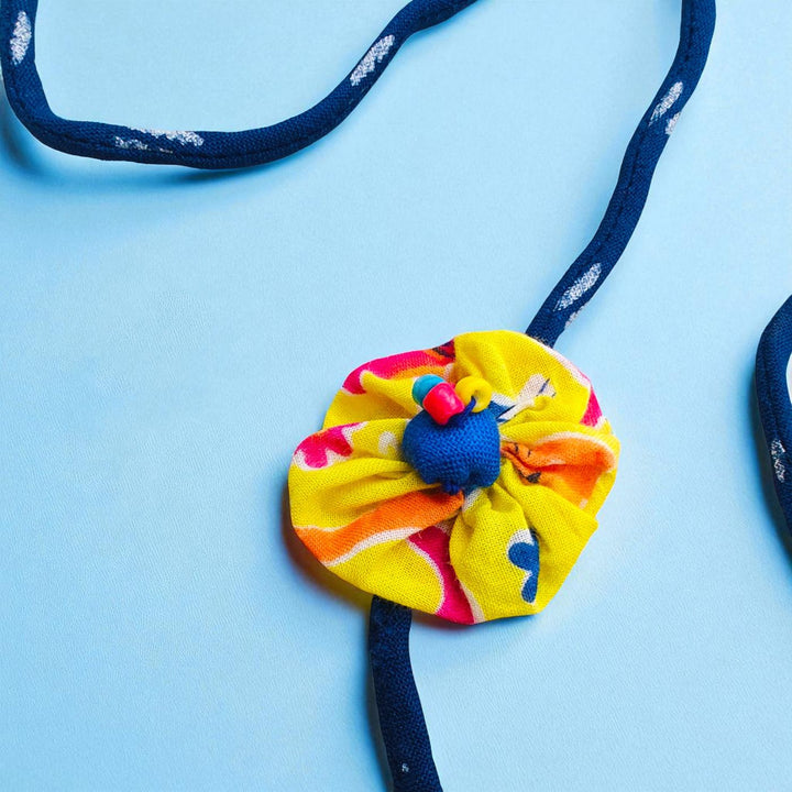 Handmade Yellow Flower Pom Pom Upcycled Fabric Rakhi With Roli Chawal For Brother - Detail Close-up of Strap and Flower