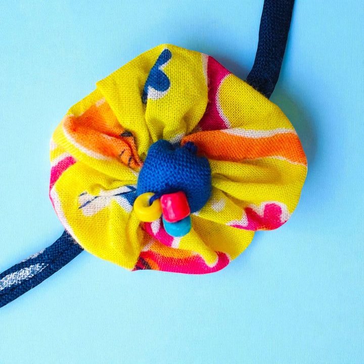 Handmade Yellow Flower Pom Pom Upcycled Fabric Rakhi With Roli Chawal For Brother - Flower and Beads Close-up
