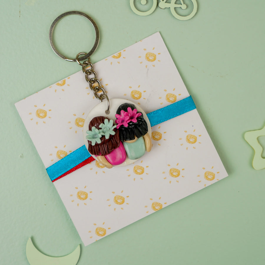 Handmade Reusable Twin Sisters Keychain Clay Rakhi With Roli Chawal - Front View on Card