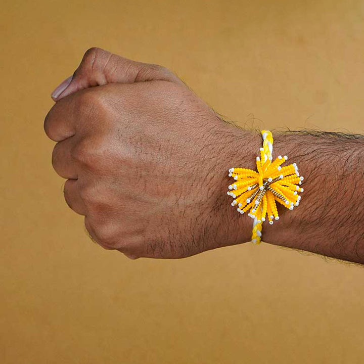 Reusable Beaded Yellow Flower Rakhi With Roli Chawal - Model Wrist Wearing Bracelet
