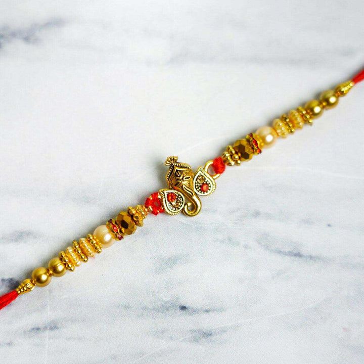 Personalized Embroidered Dark Grey Cotton Towel Rakhi Hamper With Roli Chawal For Brother Includes 1 Hand Towel 1 Bath Towel And 1 Rakhi - Close-up of Rakhi Centerpiece