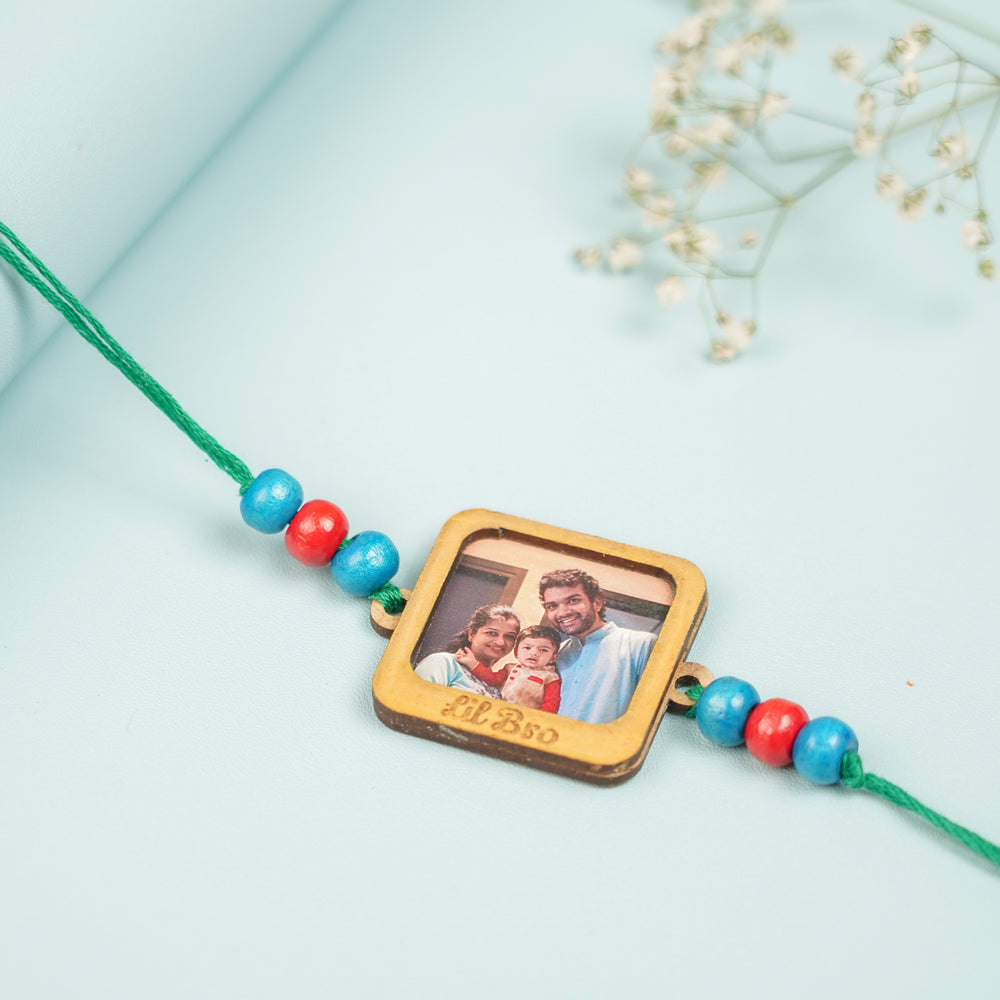 Photo Personalized Printed My First Mdf Wood Rakhi - Close-up View on Fabric Surface