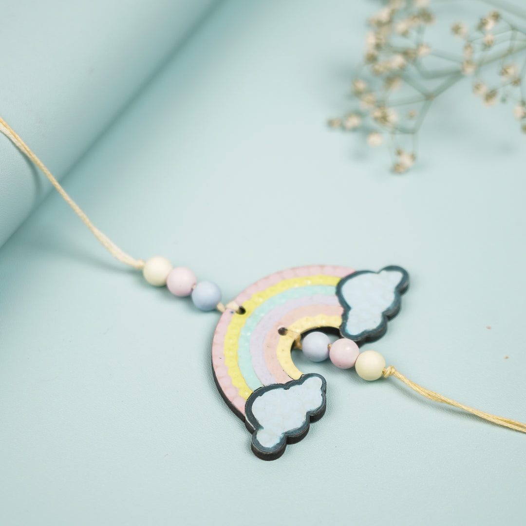 Hand Painted Rainbow Design Mdf Wood Kids Rakhi - Close-up View on Folded Background