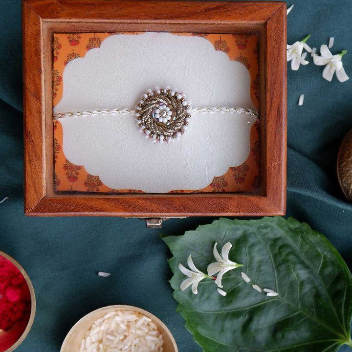 Handmade Zardozi White Bead Work Rakhi With Wooden Box And Roli Chawal - Top view in wooden box