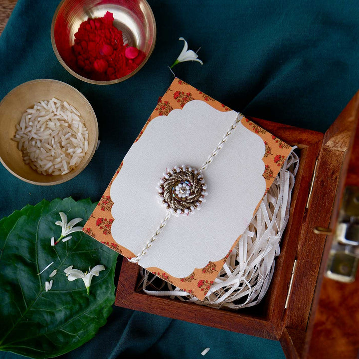 Handmade Zardozi White Bead Work Rakhi With Wooden Box And Roli Chawal - Packaging in decorative box
