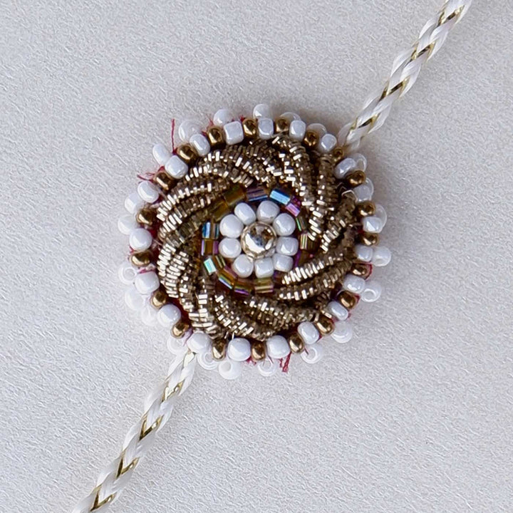 Handmade Zardozi White Bead Work Rakhi With Wooden Box And Roli Chawal - Close-up on embroidery detail