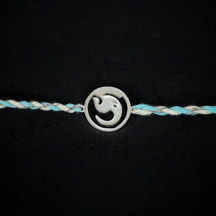 Handmade Ashtavinayak 925 Silver Rakhi With Roli Chawal For Brother - Close-up of symbol charm