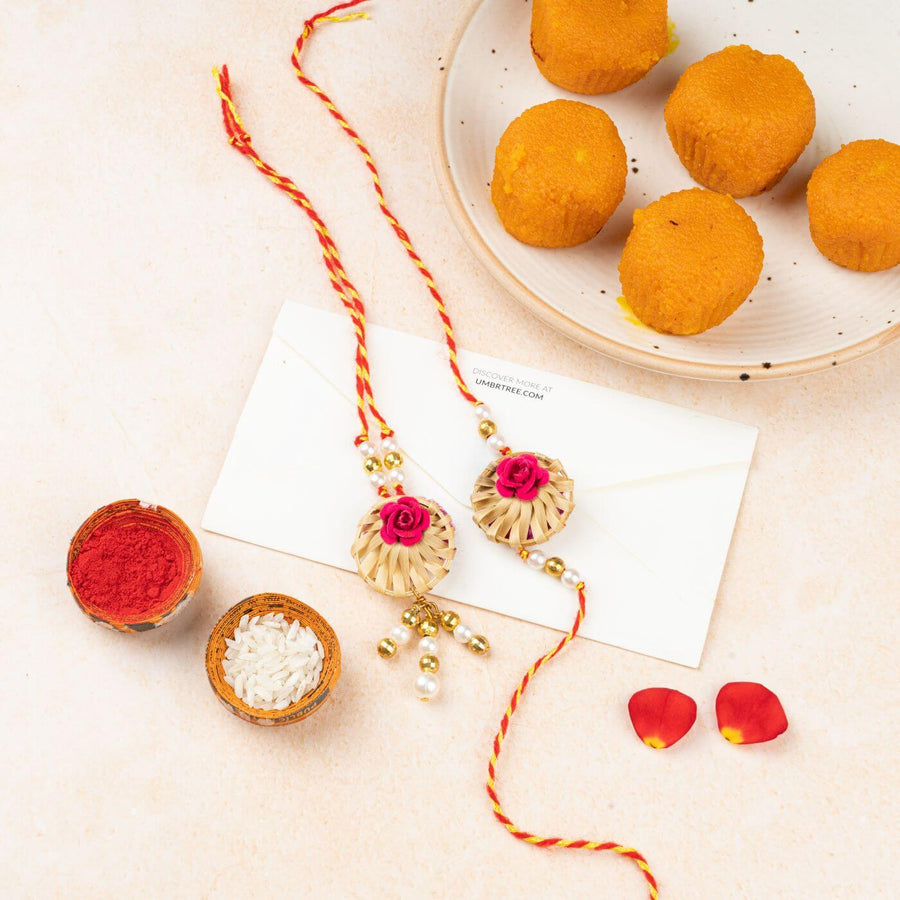 Ecofriendly Bamboo Rakhis For Bhaiya Bhabhi With Roli Chawal 5 - Flat Lay with Rakhi and Sweets