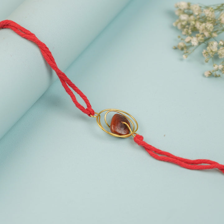 Handmade Tamarind Spiral Design Seed Rakhi For Brother - Close-up of Central Pendant