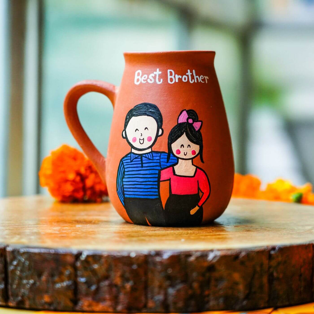 Personalized Best Brother Terracotta Mug And Rakhi Set - Front View with Blurred Background