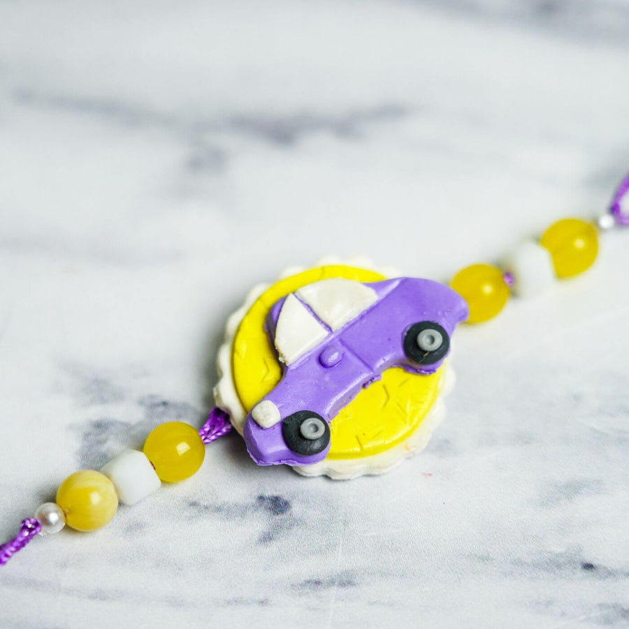 Handmade Porcelain Clay Themed Rakhi 9 - Close-up of Purple Car Charm