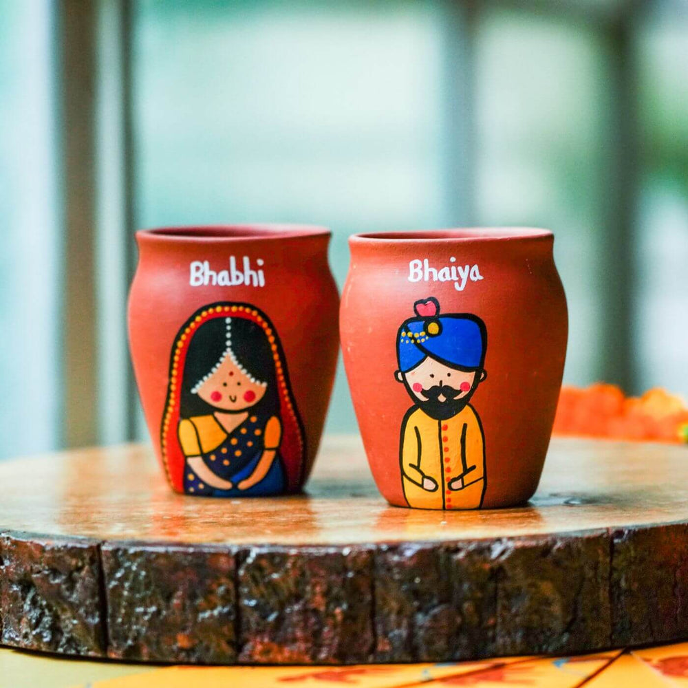 Handpainted Terracotta Kulhads Rakhi Set For Siblings - Close-up on Painted Earthen Pots