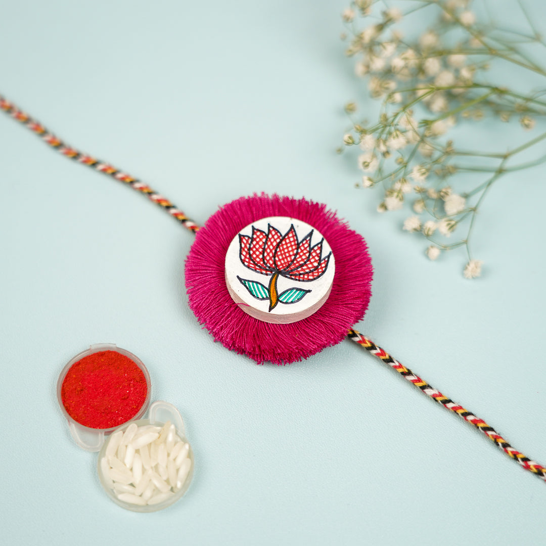 Hand Painted Madhubani Red Lotus Design Wooden Rakhi With Roli Chawal For Brother - Close-up with Accessories