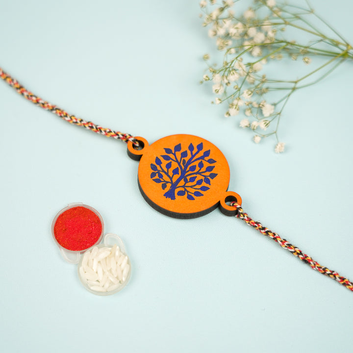 Hand Painted Pattachitra Tree Of Life Design Wooden Rakhi With Roli Chawal For Brother - Front View with Tikka and Rice
