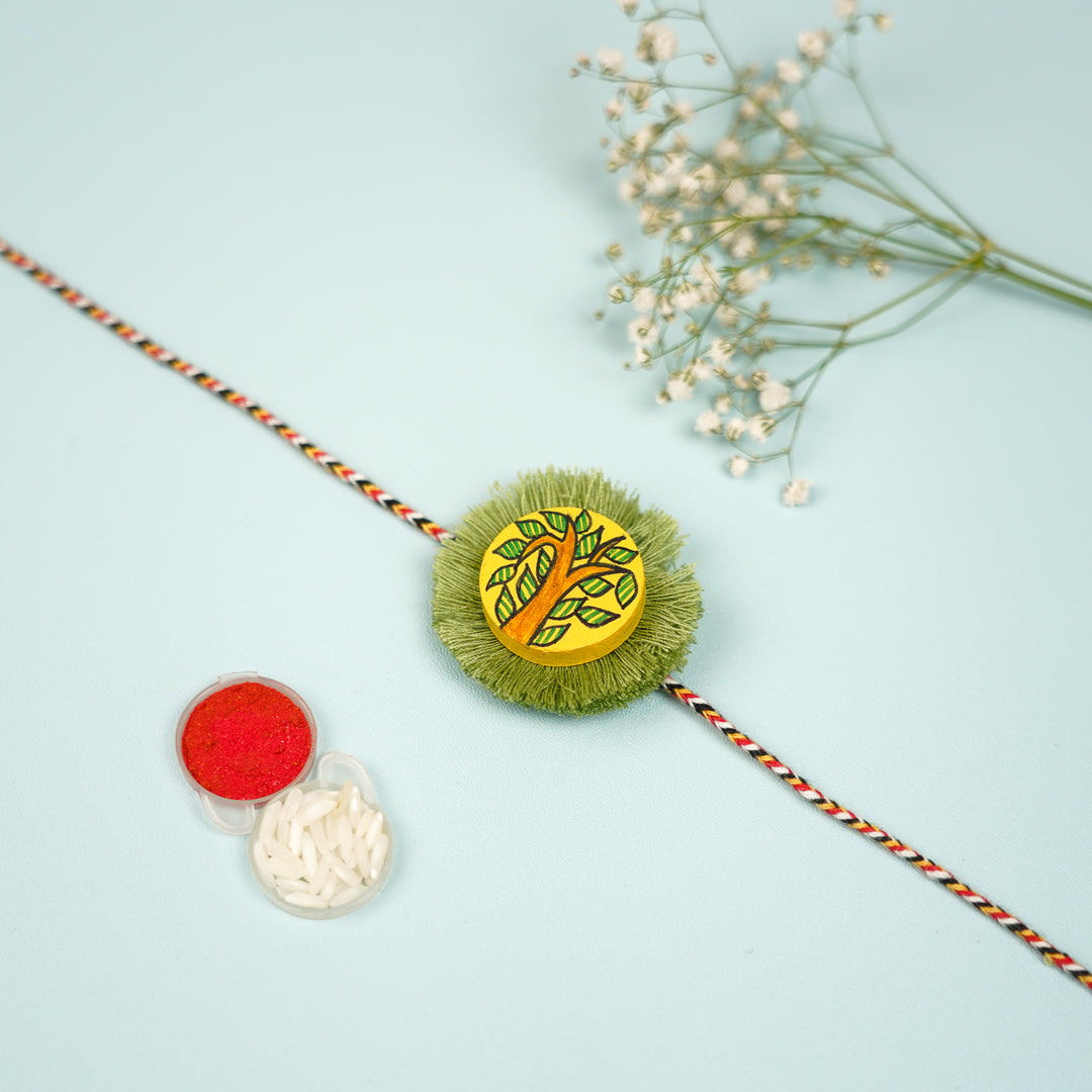 Hand Painted Madhubani Tree With Leaves Design Beads Wooden Rakhi With Roli Chawal For Brother - Flat Lay with Accessories