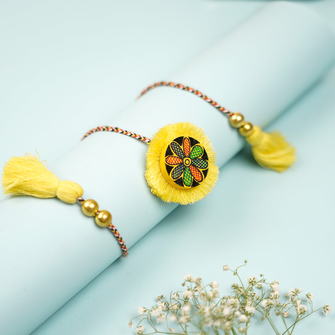 Hand Painted Madhubani Yellow Flower Design Wooden Rakhi With Roli Chawal For Brother - Wrapped Around Rolled Paper Display