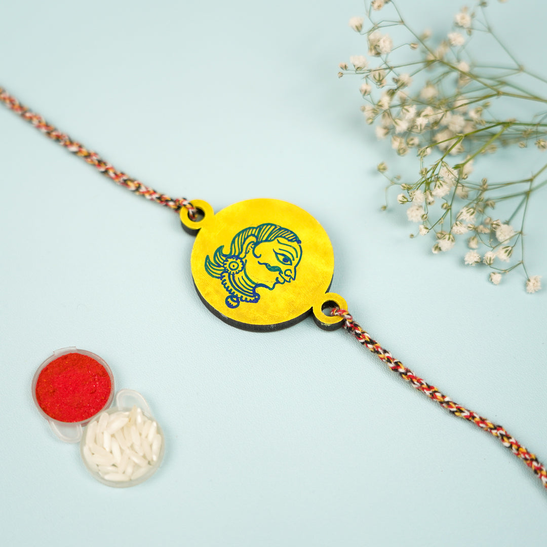 Hand Painted Pattachitra Raja Design Wooden Rakhi With Roli Chawal For Brother - Flat Lay with Accessories