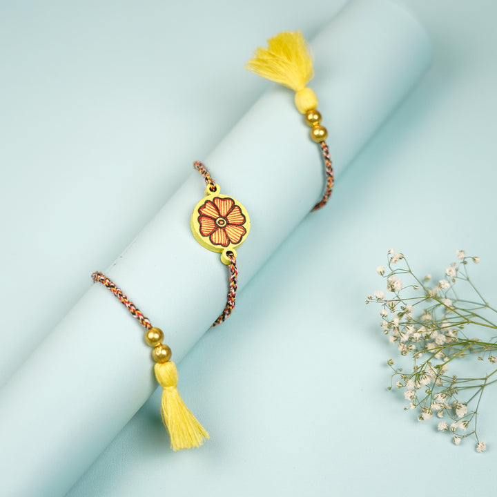 Hand Painted Madhubani Yellow Flower Design And Beads Wooden Rakhi With Roli Chawal For Brother - Wrapped Around Cylinder Display