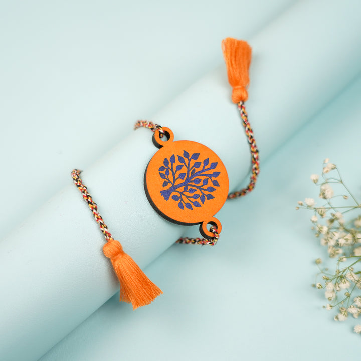 Hand Painted Pattachitra Tree Of Life Design Wooden Rakhi With Roli Chawal For Brother - Styled Draped Display on Cylinder