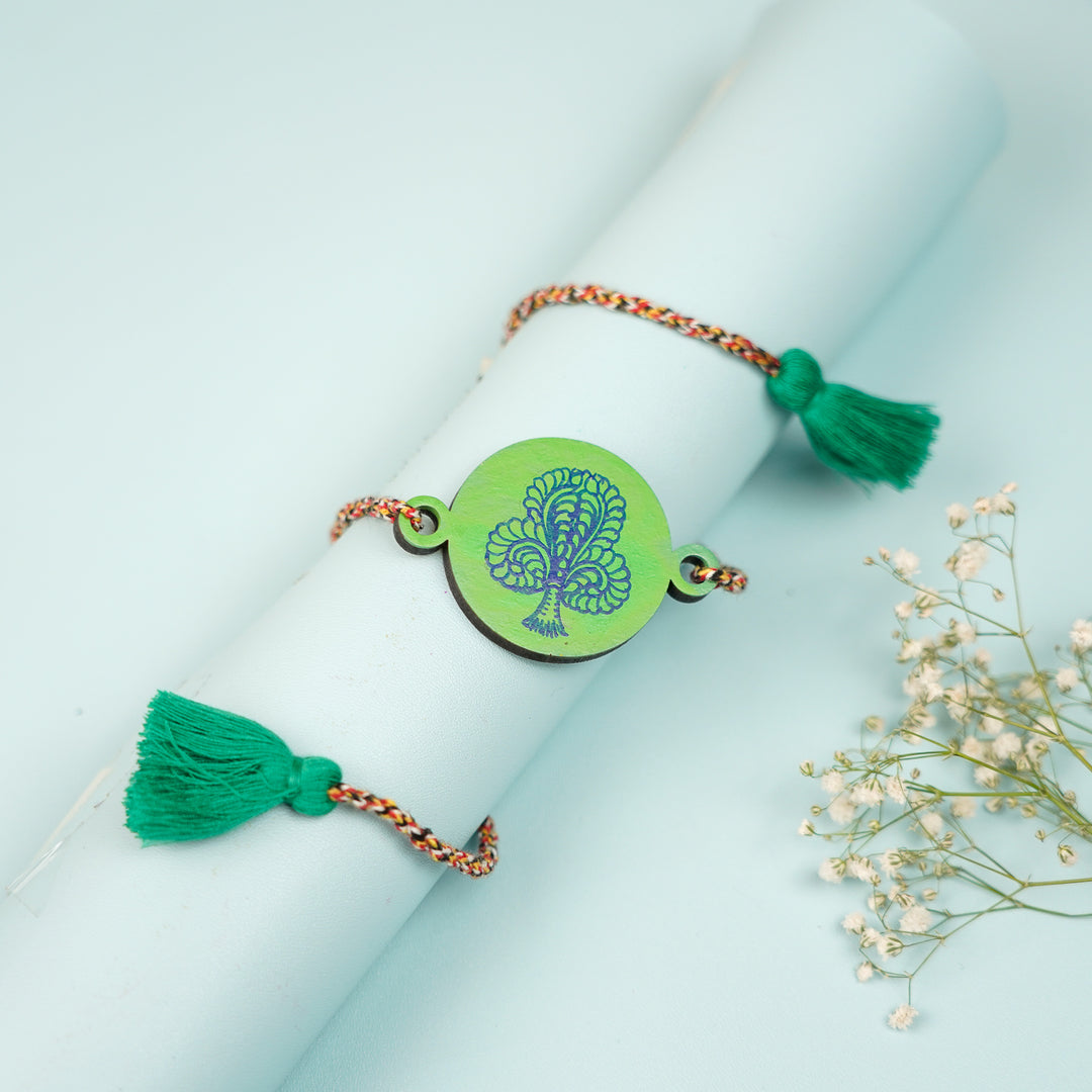 Hand Painted Pattachitra Peacock Feather Design Wooden Rakhi With Roli Chawal For Brother - Styled on rolled paper with tassels