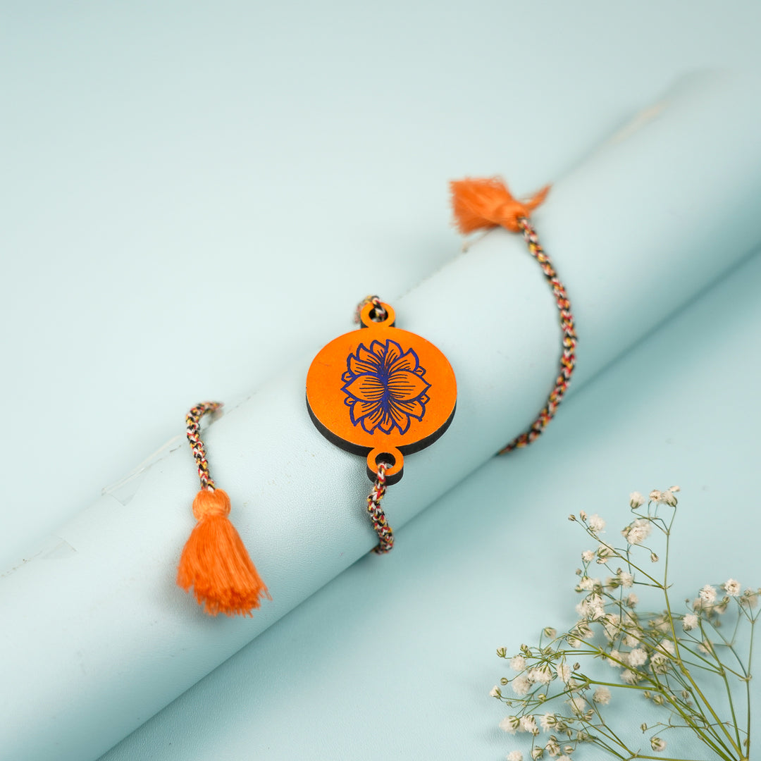 Hand Painted Pattachitra Orange Lotus Design Wooden Rakhi With Roli Chawal For Brother - Wrapped Around Wrist Display