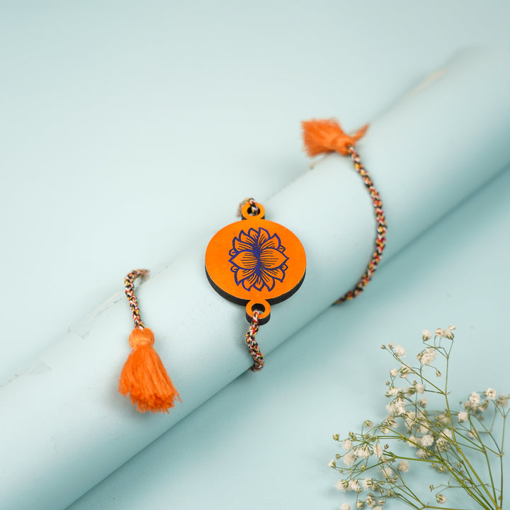 Hand Painted Pattachitra Orange Lotus Design Wooden Rakhi With Roli Chawal For Brother - Wrapped Around Wrist Display