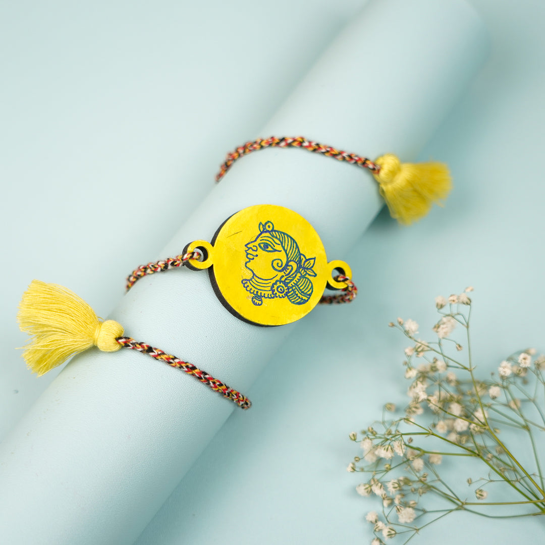 Hand Painted Pattachitra Rani Design Wooden Rakhi With Roli Chawal For Brother - Rolled Display on Cylinder