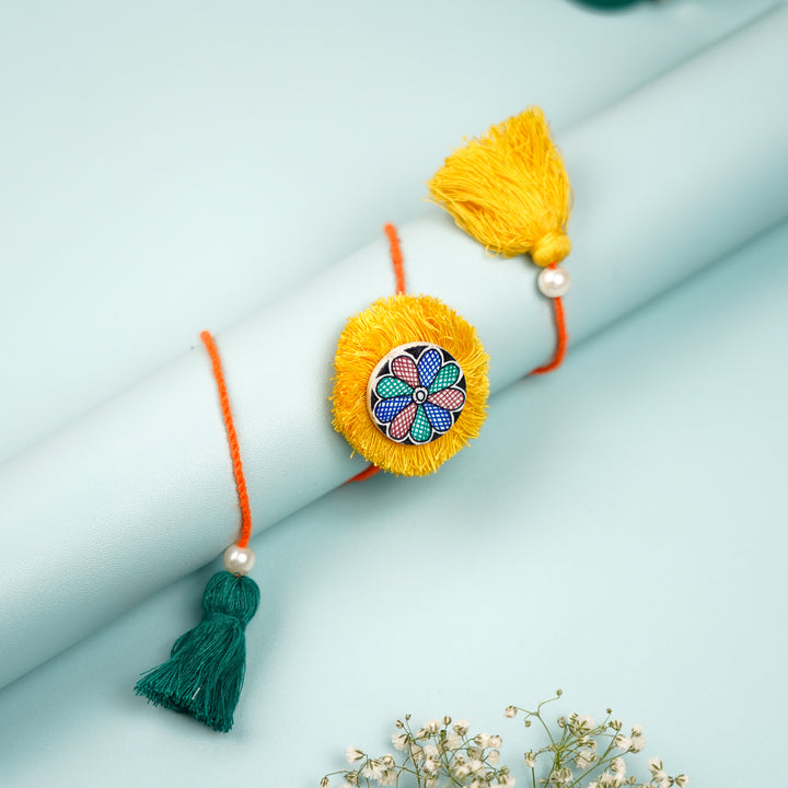 Hand Painted Madhubani Flower Design Wooden Rakhi With Roli Chawal For Brother - Close-up on Display with Tassels