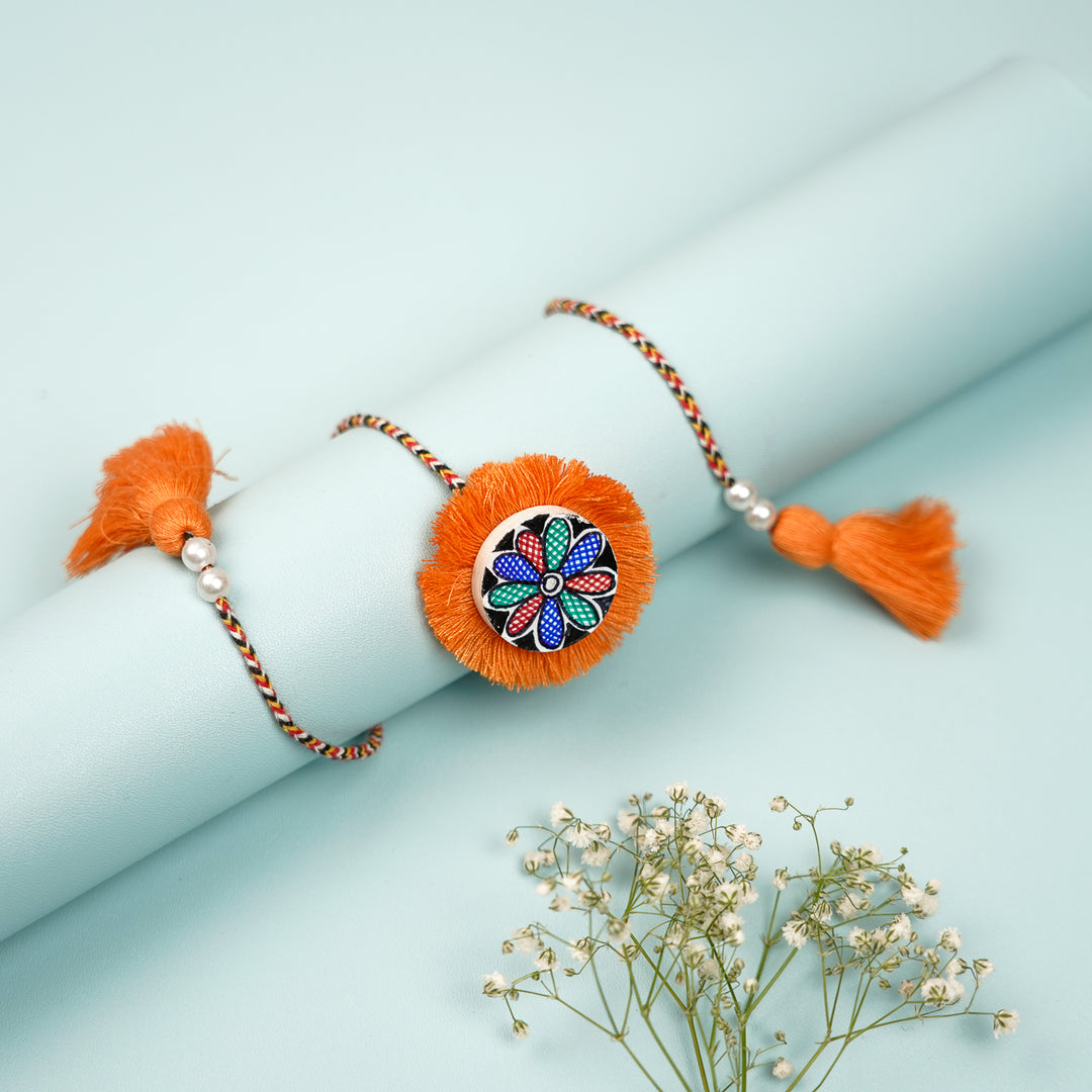 Hand Painted Madhubani Orange Flower Design Beads Wooden Rakhi With Roli Chawal For Brother - Wrapped on Cylindrical Display Bar
