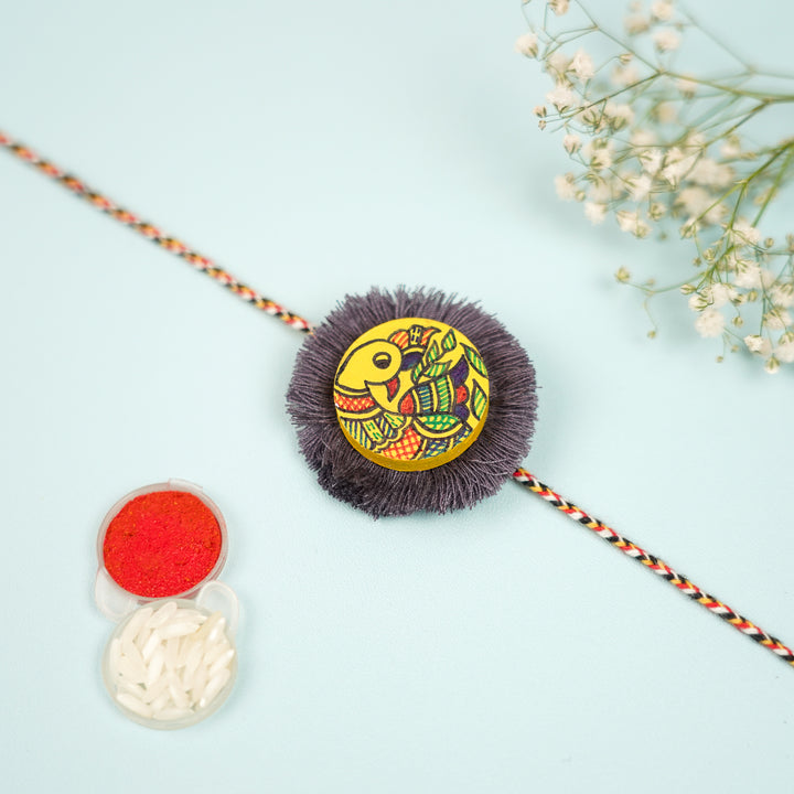 Hand Painted Madhubani Peacock Design Wooden Rakhi With Roli Chawal For Brother - Flat Lay with Accessories