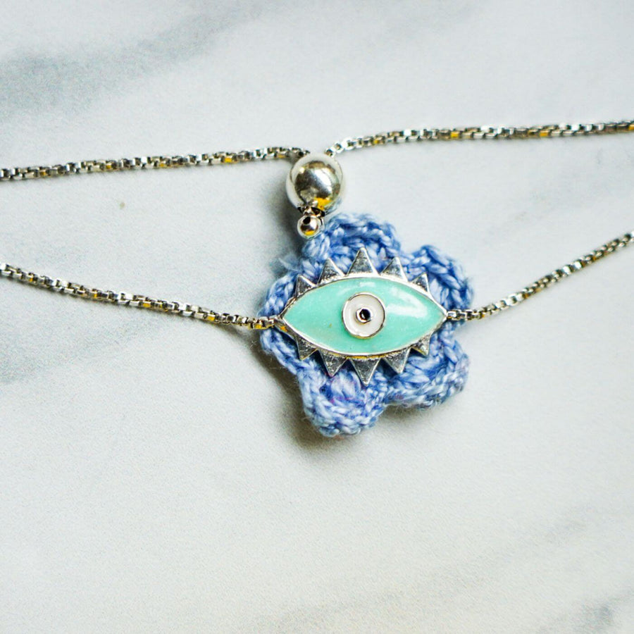 Handcrafted Evil Eye Silver Strap Rakhi For Kids With Rice Roli - Close-up of Pendant Detail