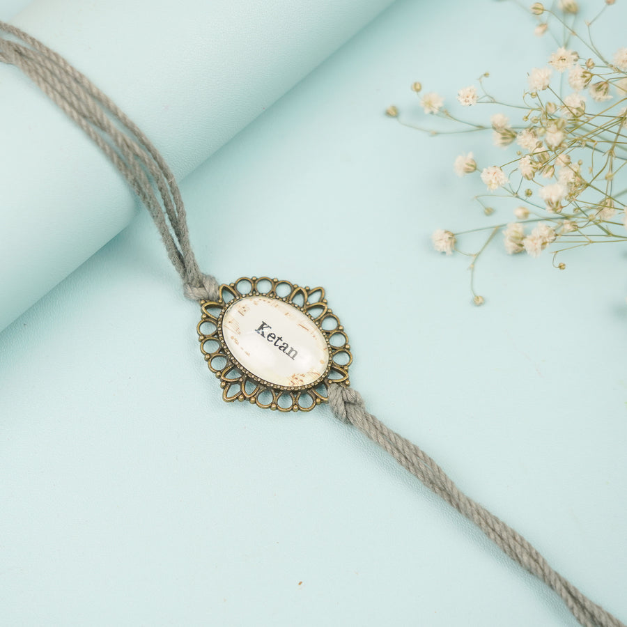 Photo Personalized Handmade Oval Antique Bronze Rakhi With Roli Chawal Copy - Close-up of Personalized Bracelet