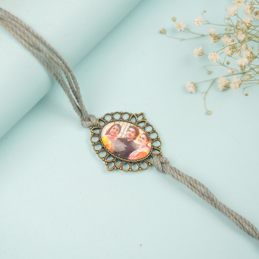 Photo Personalized Handmade Oval Antique Bronze Rakhi With Roli Chawal - Close-up of Personalized Rakhi
