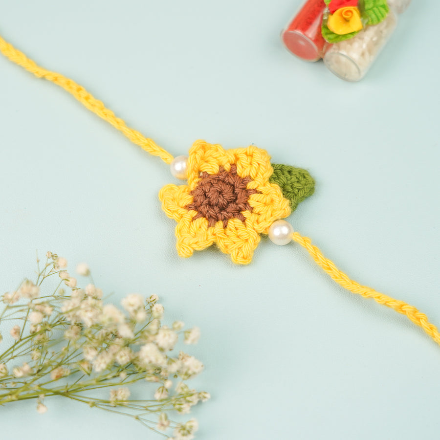 Handmade Crochet Sunflower Rakhi With Roli Chawal 2 - Close-up of sunflower bracelet