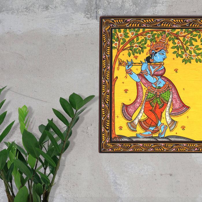 Pattachitra Board Krishna - Mounted on Wall with Plant Nearby