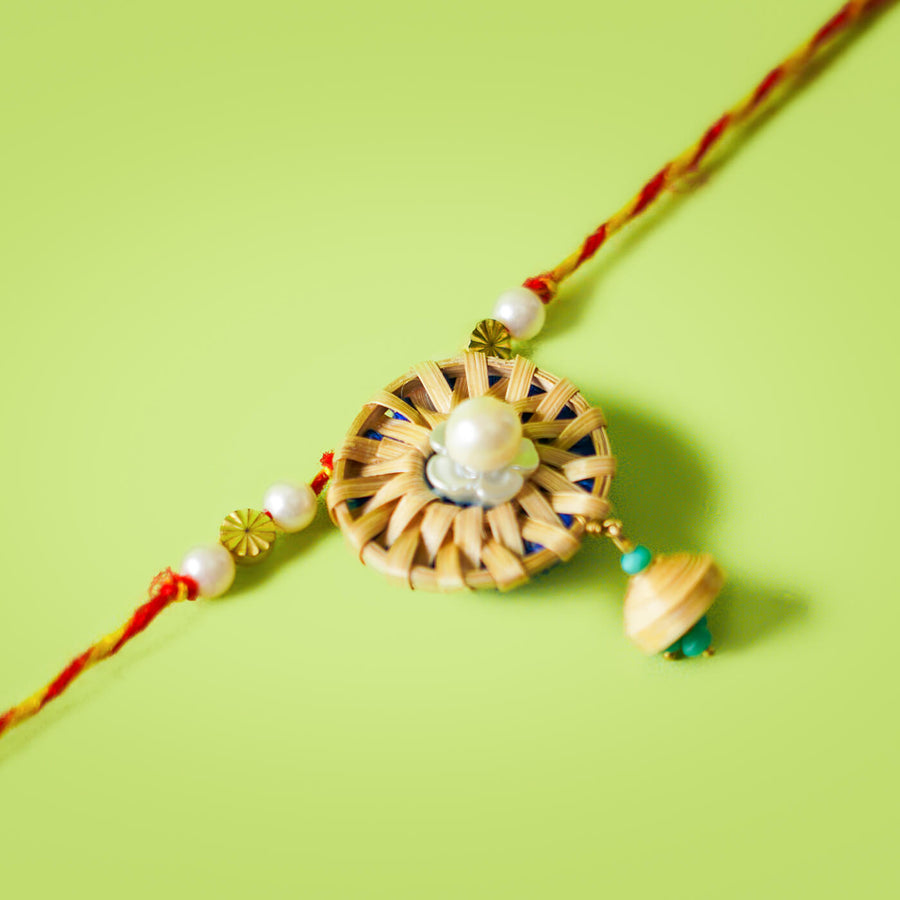 Ecofriendly Bamboo Lumba Rakhi With Green Quilled Jhumki Pearl - Close-up of Rakhi centerpiece