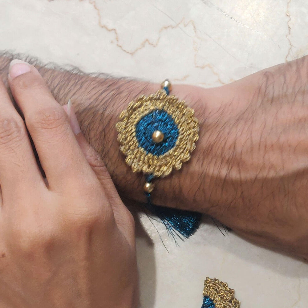 Peacock Blue Gold Bhaiya Lumba Rakhi - Worn on Wrist Close-up