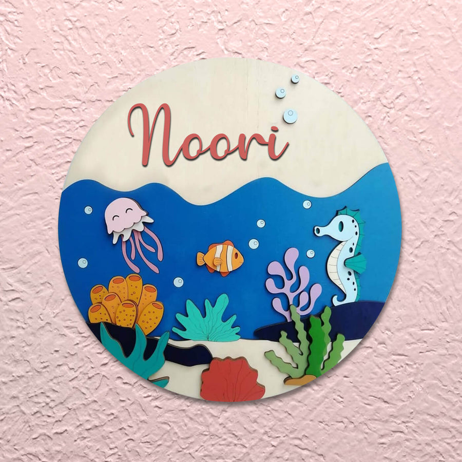Painted Name Plate For Kids Under The Water - Mounted on textured pink wall