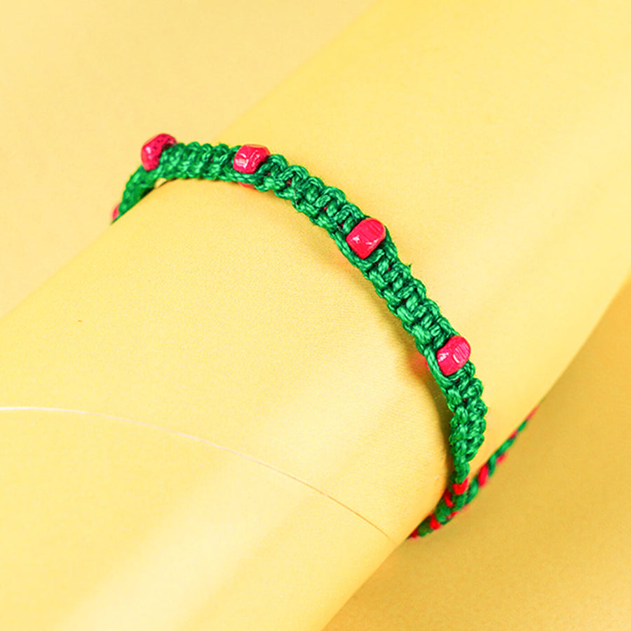 Green Macrame Cotton Rakhi With Pink Beads - Close-up of Bracelet on Display