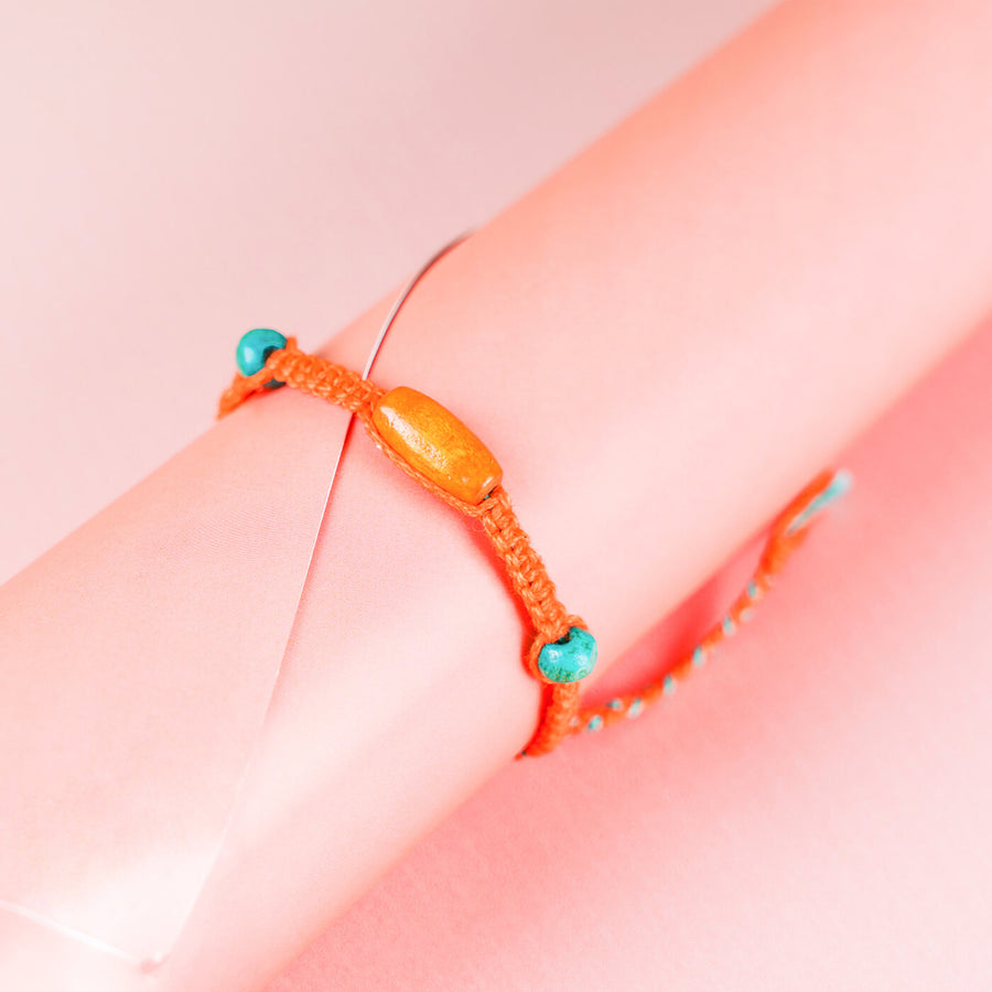 Orange Macrame Cotton Rakhi With Orange Teal Beads - Bracelet Close-up on Wrist