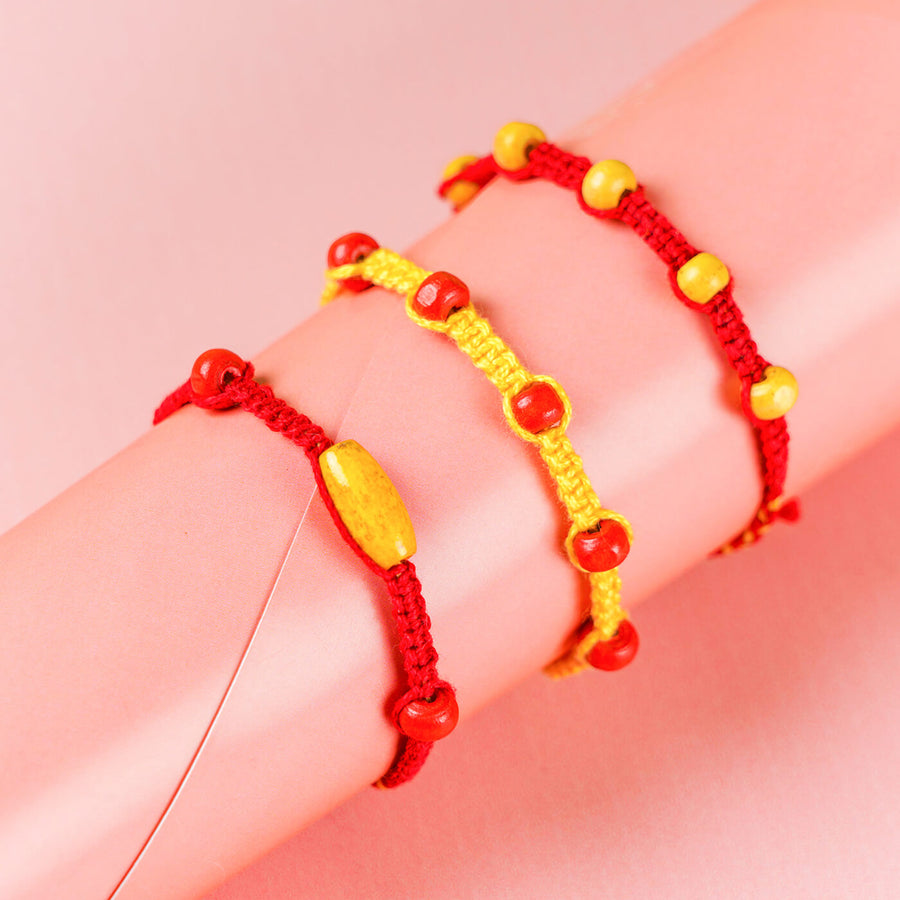 Red Yellow Rakhi With Beads Set Of 3 - Bracelets on wrist close-up