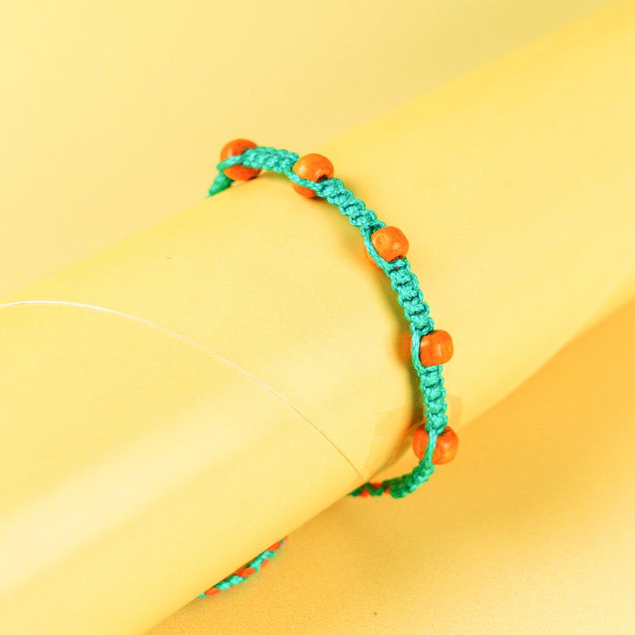 Teal Macrame Cotton Rakhi With Orange Beads - Close-up on bracelet details